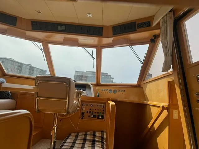  Yacht Photos Pics Interior of 2000 McKinna 57 Pilothouse with helm station and panoramic windows.