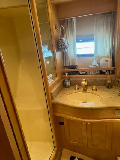  Yacht Photos Pics Luxurious bathroom in 2000 McKinna 57 Pilothouse yacht with gold fixtures and marble countertop.
