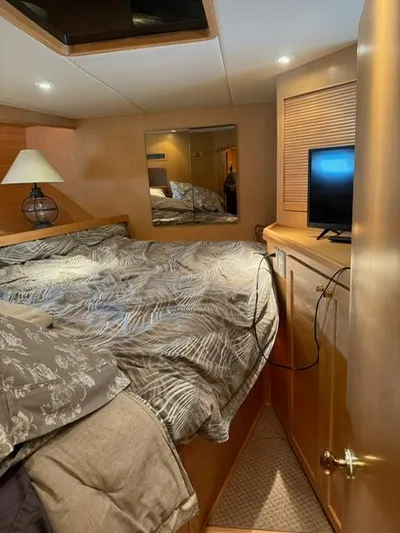  Yacht Photos Pics Cozy bedroom in 2000 McKinna 57 Pilothouse yacht with TV and mirror.