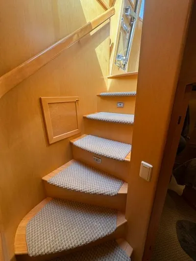  Yacht Photos Pics Staircase in 2000 McKinna 57 Pilothouse yacht with carpeted steps and wooden handrail.