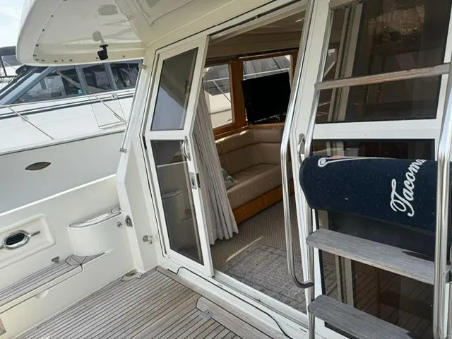  Yacht Photos Pics 2000 McKinna 57 Pilothouse yacht with open sliding door and interior view.