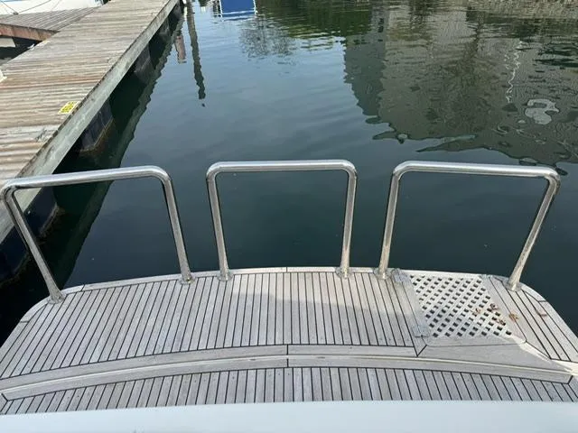  Yacht Photos Pics McKinna 57 Pilothouse 2000 yacht stern with wooden deck and metal railings.