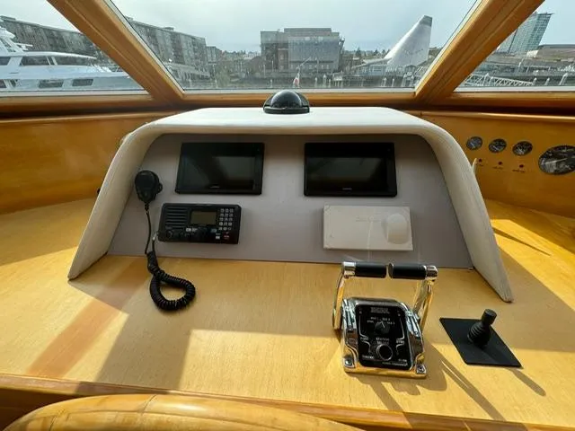  Yacht Photos Pics Pilothouse of 2000 McKinna 57 yacht with navigation controls and cityscape view.