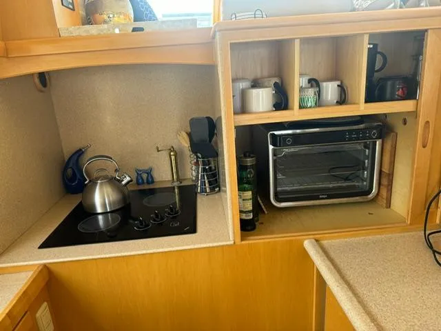  Yacht Photos Pics Compact kitchen in 2000 McKinna 57 Pilothouse with stove, kettle, and toaster oven.