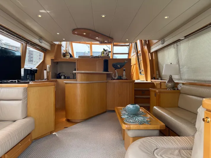  Yacht Photos Pics Luxurious interior of 2000 McKinna 57 Pilothouse yacht with elegant wood finishes.