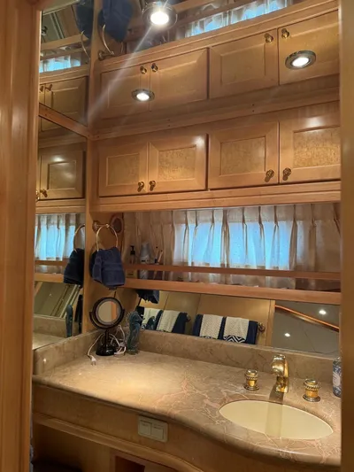  Yacht Photos Pics Luxurious bathroom in 2000 McKinna 57 Pilothouse yacht with wood cabinetry and marble countertop.