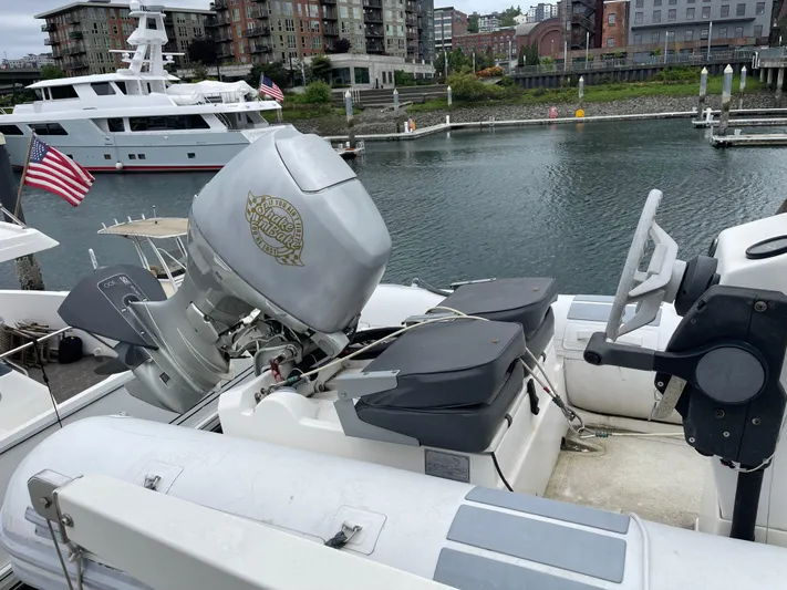  Yacht Photos Pics 2000 McKinna 57 Pilothouse yacht docked in marina, featuring outboard motor and American flag.