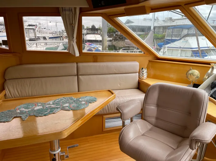  Yacht Photos Pics Interior of 2000 McKinna 57 Pilothouse yacht with leather seating and wooden accents.