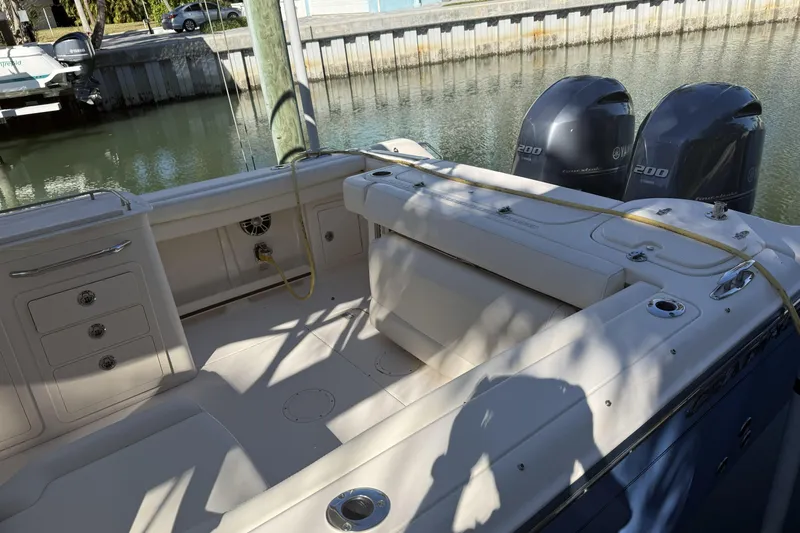 275-264 Brokerage Joe Yacht Photos Pics 2022 Grady-White Freedom 275 boat interior with dual Yamaha engines docked by water.
