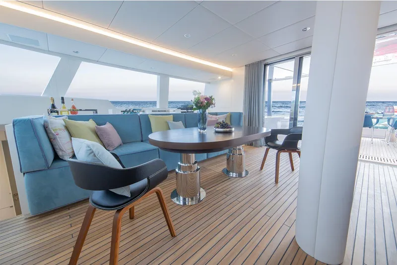  Yacht Photos Pics Luxurious interior of 2026 Sunreef 60 yacht with elegant seating and ocean view.