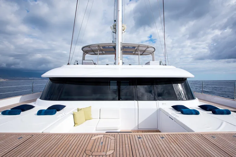  Yacht Photos Pics Luxurious 2026 Sunreef 60 yacht deck with plush seating and ocean view.