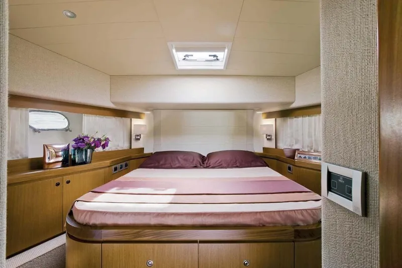  Yacht Photos Pics Luxurious bedroom interior of 2008 Ferretti Yachts 681 with elegant wood finishes.