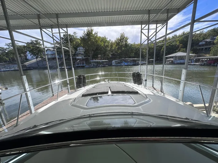 Crash Money Yacht Photos Pics 2007 Sea Ray 44 Sundancer docked at a scenic lakeside marina.