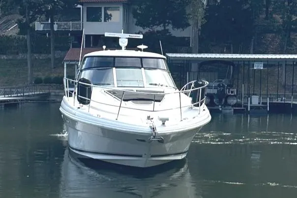 Crash Money Yacht Photos Pics 2007 Sea Ray 44 Sundancer yacht docked on calm water.