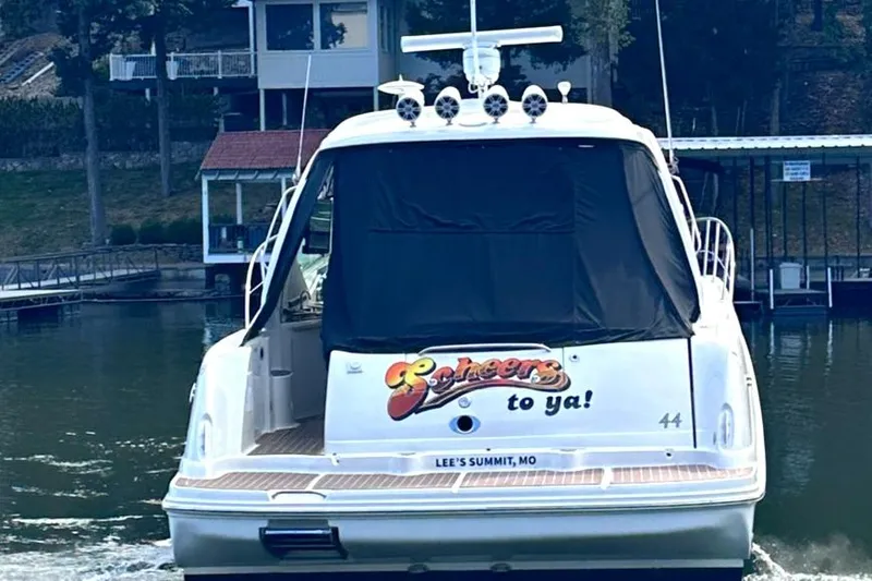 Crash Money Yacht Photos Pics 2007 Sea Ray 44 Sundancer yacht on water, rear view, docked near houses.