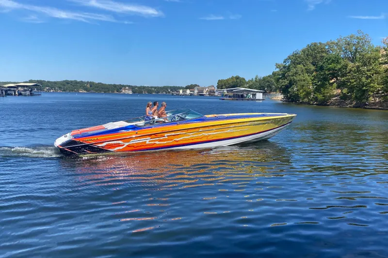  Yacht Photos Pics 2008 Formula 382 FASTech speedboat with vibrant graphics cruising on a sunny lake.