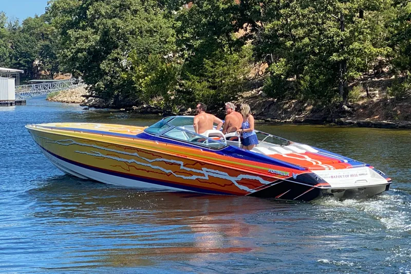 Yacht Photos Pics 2008 Formula 382 FASTech speedboat with vibrant graphics cruising on a scenic lake.