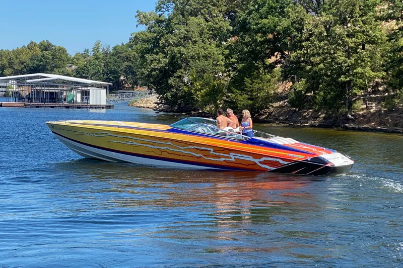 Yacht Photos Pics 2008 Formula 382 FASTech speedboat with vibrant graphics cruising on a scenic lake.