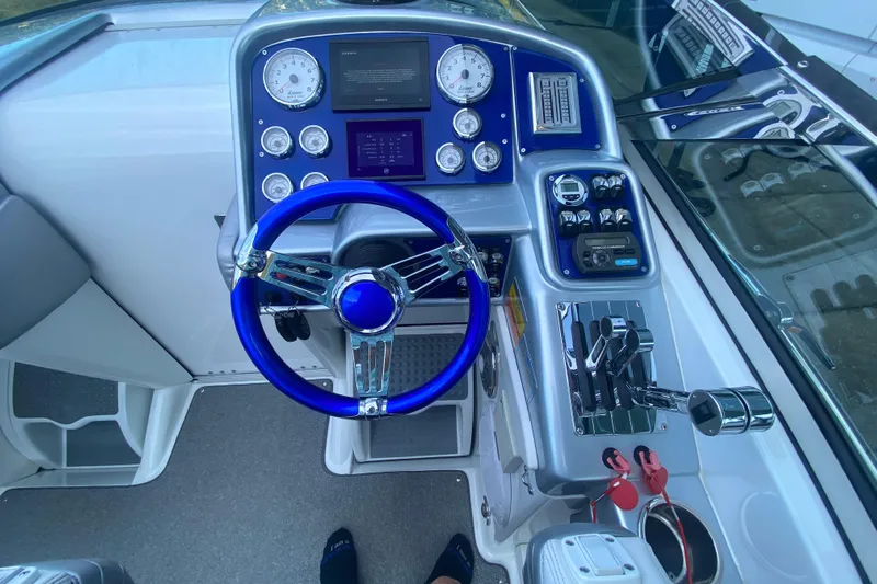  Yacht Photos Pics 2008 Formula 382 FASTech boat cockpit with blue steering wheel and control panel.