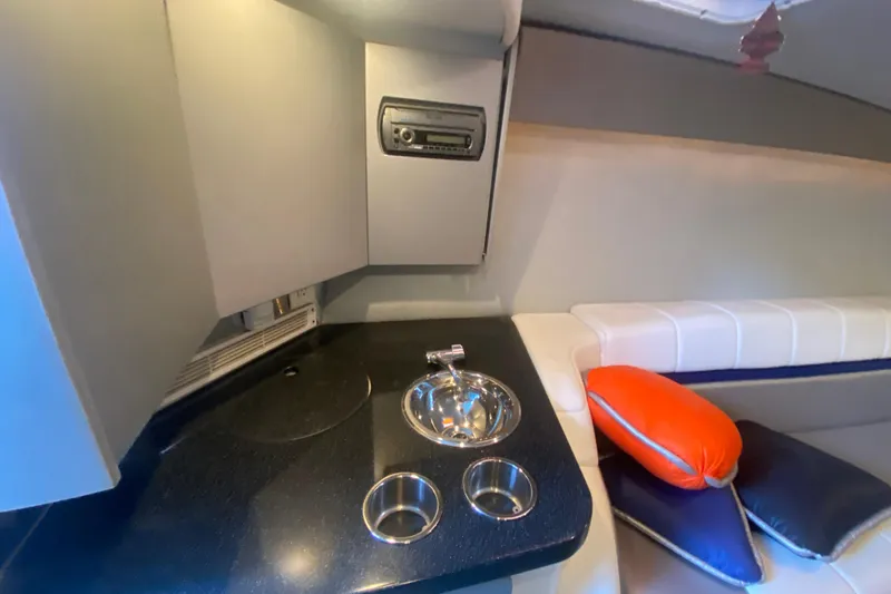  Yacht Photos Pics 2008 Formula 382 FASTech cabin interior with sink, stereo, and seating area.