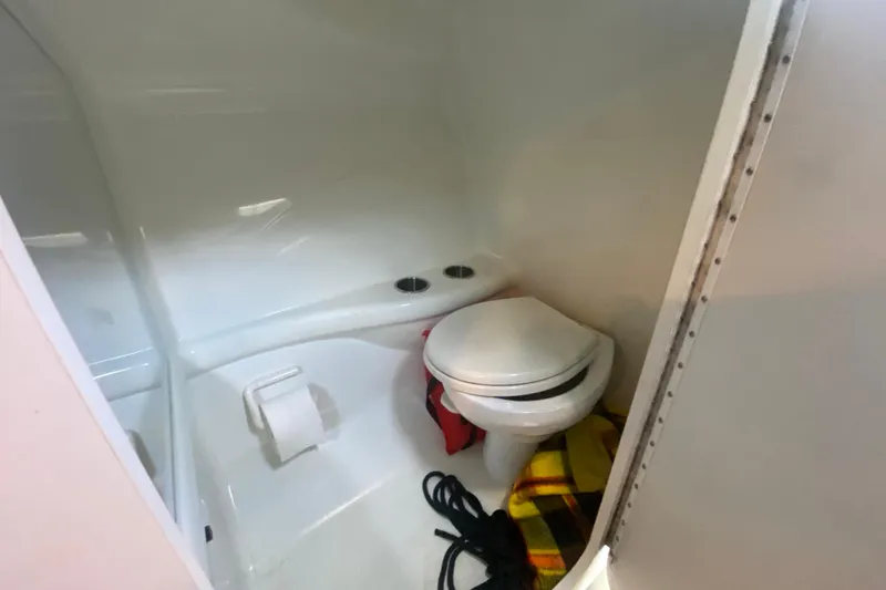  Yacht Photos Pics 2008 Formula 382 FASTech boat bathroom with toilet, paper holder, and storage items.