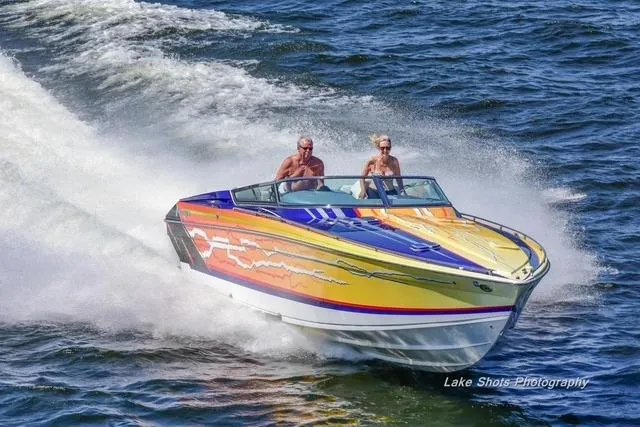  Yacht Photos Pics 2008 Formula 382 FASTech speedboat with vibrant graphics cruising on open water.