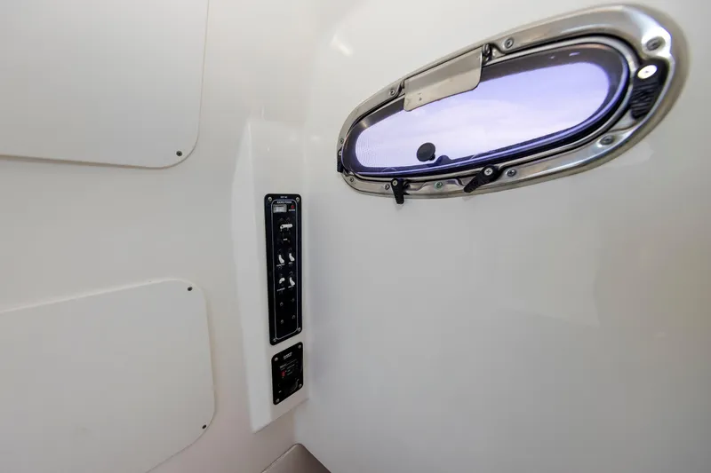 Murphy's Law Yacht Photos Pics Interior view of 2016 Boston Whaler 330 Outrage with porthole and control panel.