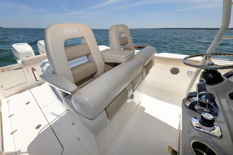 Murphy's Law Yacht Photos Pics 2016 Boston Whaler 330 Outrage boat interior with helm and seating, on open water.