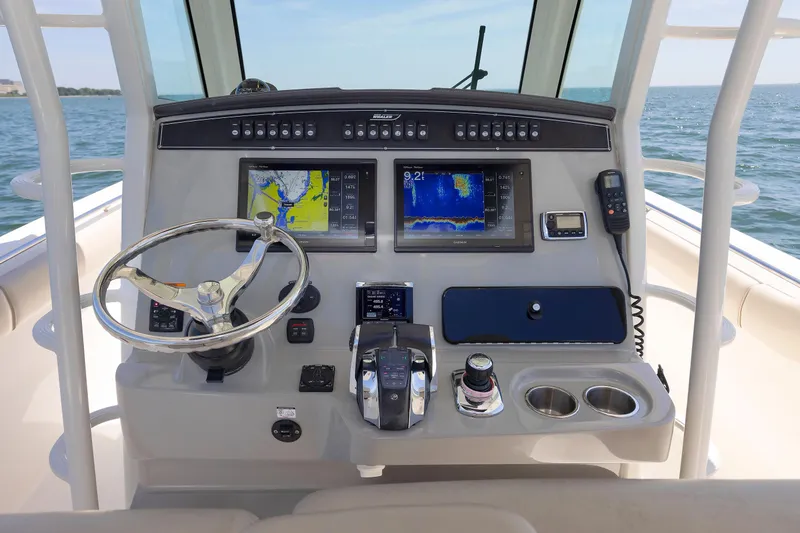 Murphy's Law Yacht Photos Pics Control panel of 2016 Boston Whaler 330 Outrage with navigation screens and steering wheel.
