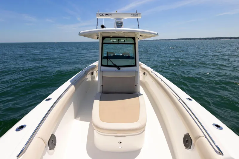 Murphy's Law Yacht Photos Pics Boston Whaler 330 Outrage 2016 boat on open water, featuring spacious deck and clear skies.