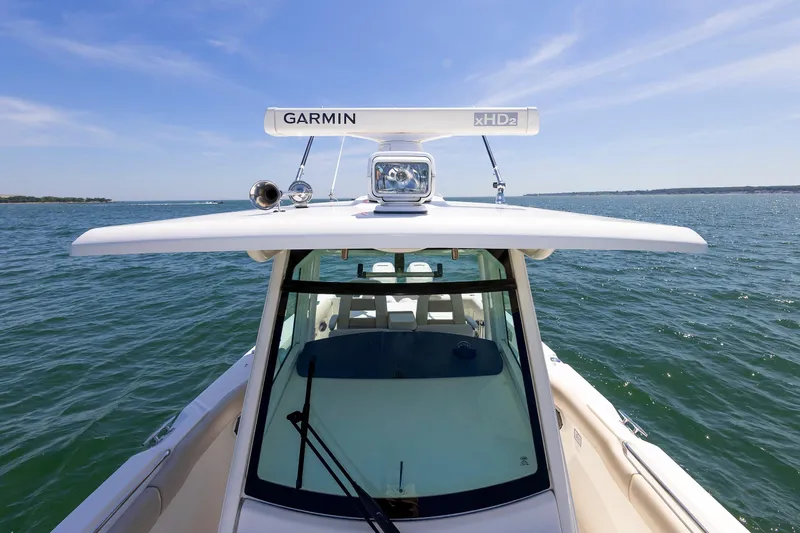 Murphy's Law Yacht Photos Pics 2016 Boston Whaler 330 Outrage boat on open water, featuring Garmin radar.