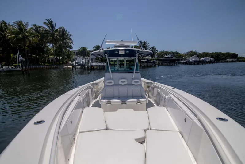 Outta Hand Yacht Photos Pics 2009 Everglades 350CC boat on calm water, featuring spacious seating and sleek design.