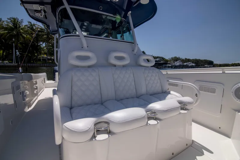 Outta Hand Yacht Photos Pics 2009 Everglades 350CC boat with white cushioned seating and cup holders.