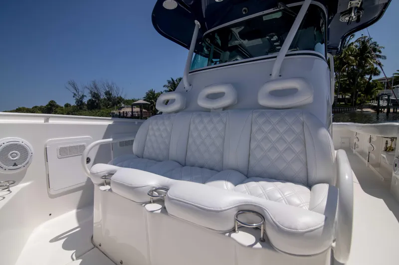 Outta Hand Yacht Photos Pics 2009 Everglades 350CC boat with luxurious white seating and cup holders.