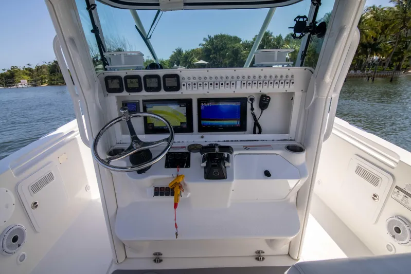 Outta Hand Yacht Photos Pics 2009 Everglades 350CC boat cockpit with steering wheel and navigation screens.