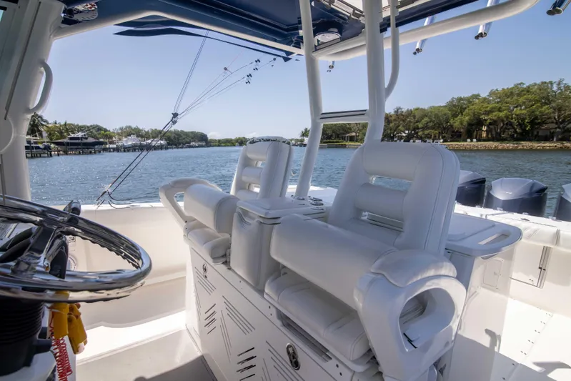 Outta Hand Yacht Photos Pics 2009 Everglades 350CC boat interior with white seating and steering wheel, overlooking calm waters.