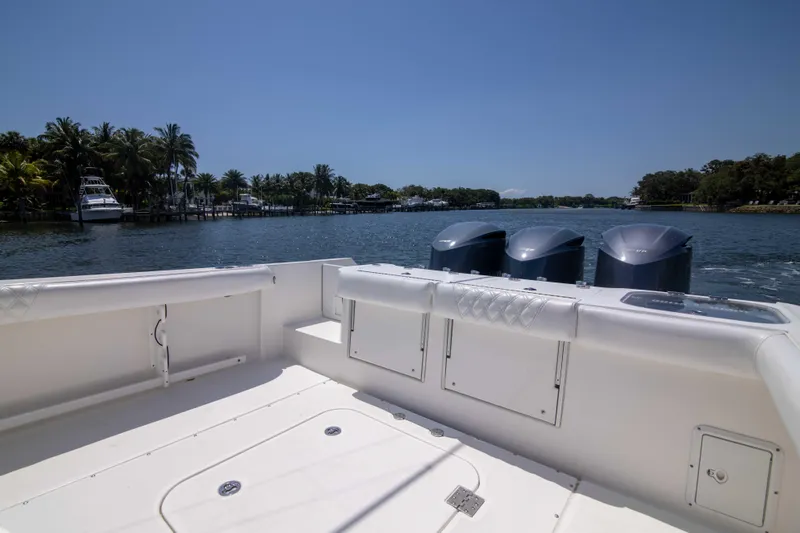 Outta Hand Yacht Photos Pics 2009 Everglades 350CC boat with triple engines on a sunny day by the water.
