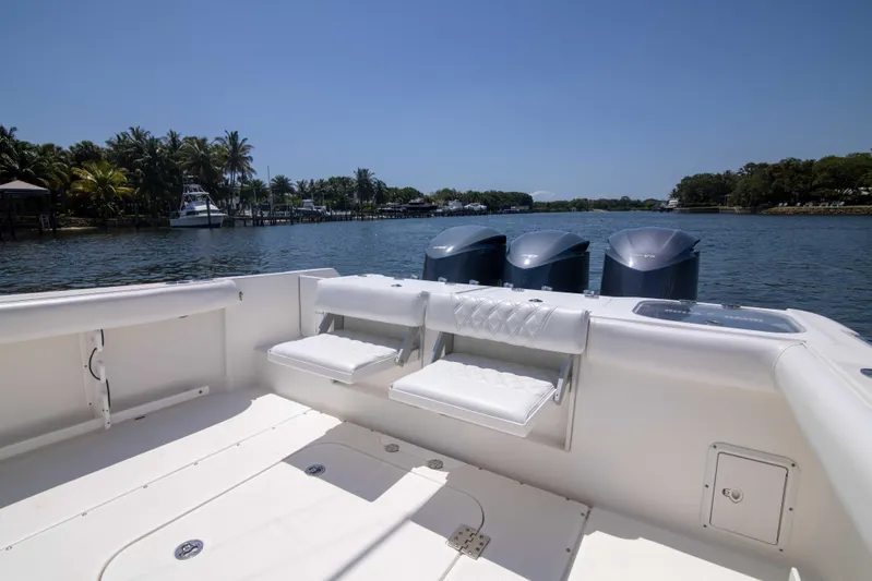 Outta Hand Yacht Photos Pics 2009 Everglades 350CC boat with triple engines on a serene waterway.