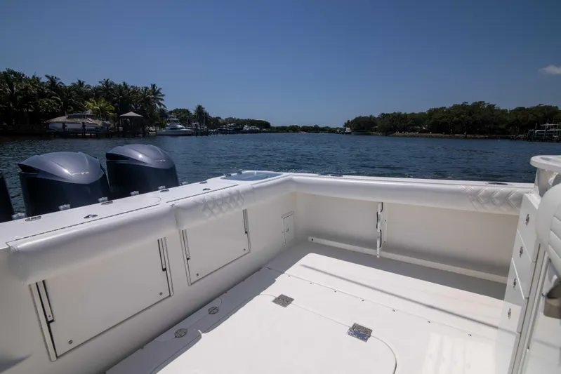Outta Hand Yacht Photos Pics 2009 Everglades 350CC boat with dual engines on a sunny day by the water.