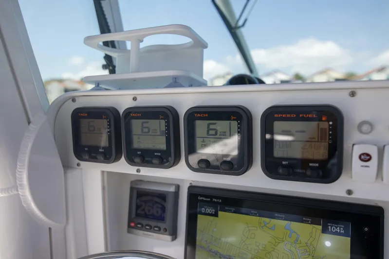 Outta Hand Yacht Photos Pics Dashboard of a 2009 Everglades 350CC boat with navigation and tachometer displays.