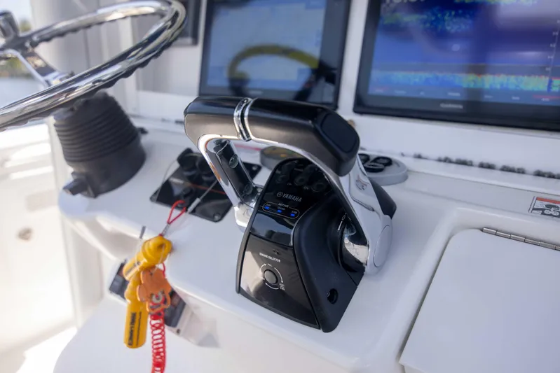 Outta Hand Yacht Photos Pics Close-up of 2009 Everglades 350CC boat controls with steering wheel and throttle.
