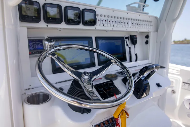 Outta Hand Yacht Photos Pics 2009 Everglades 350CC boat dashboard with steering wheel and navigation instruments.