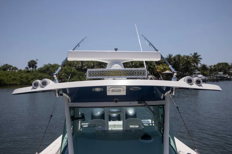 Outta Hand Yacht Photos Pics 2009 Everglades 350CC boat with fishing rods, on a calm waterway.