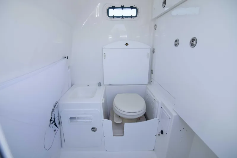 Outta Hand Yacht Photos Pics 2009 Everglades 350CC boat bathroom interior with toilet and sink.