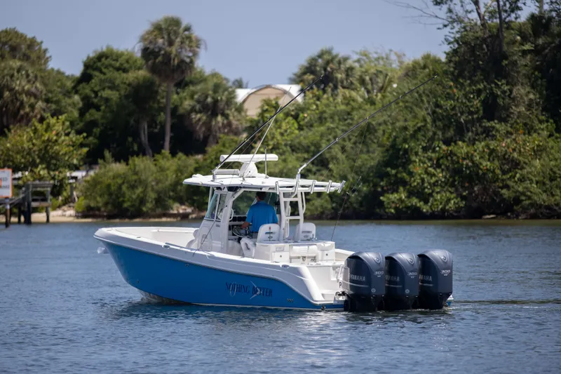Outta Hand Yacht Photos Pics 2009 Everglades 350CC boat with triple engines on a calm waterway.