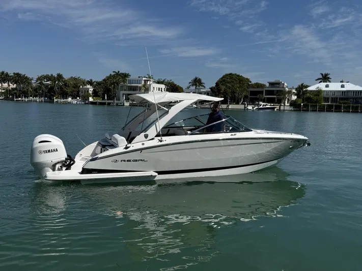  Yacht Photos Pics 2019 Regal 29 OBX boat on calm water with Yamaha outboard motor.