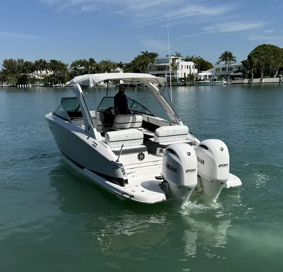  Yacht Photos Pics 2019 Regal 29 OBX boat with twin Yamaha engines on a calm waterway.