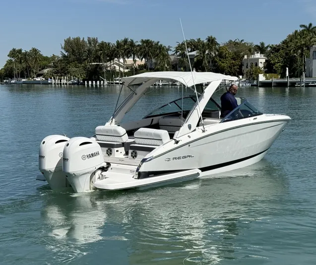  Yacht Photos Pics 2019 Regal 29 OBX boat with Yamaha engines on a calm waterway.