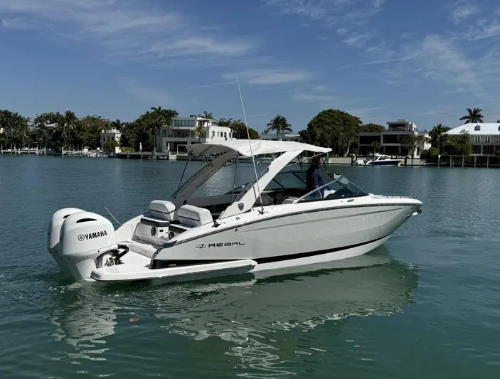  Yacht Photos Pics 2019 Regal 29 OBX boat on calm water with Yamaha outboard motor.