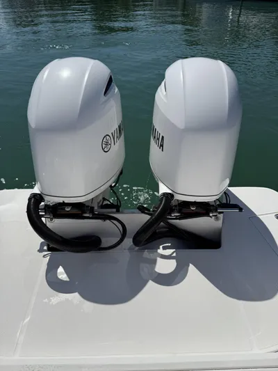  Yacht Photos Pics Twin Yamaha outboard engines on a 2019 Regal 29 OBX boat, docked on calm water.